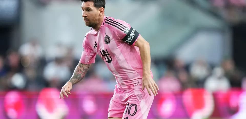 Lionel Messi corriendo en partido con camiseta rosa
