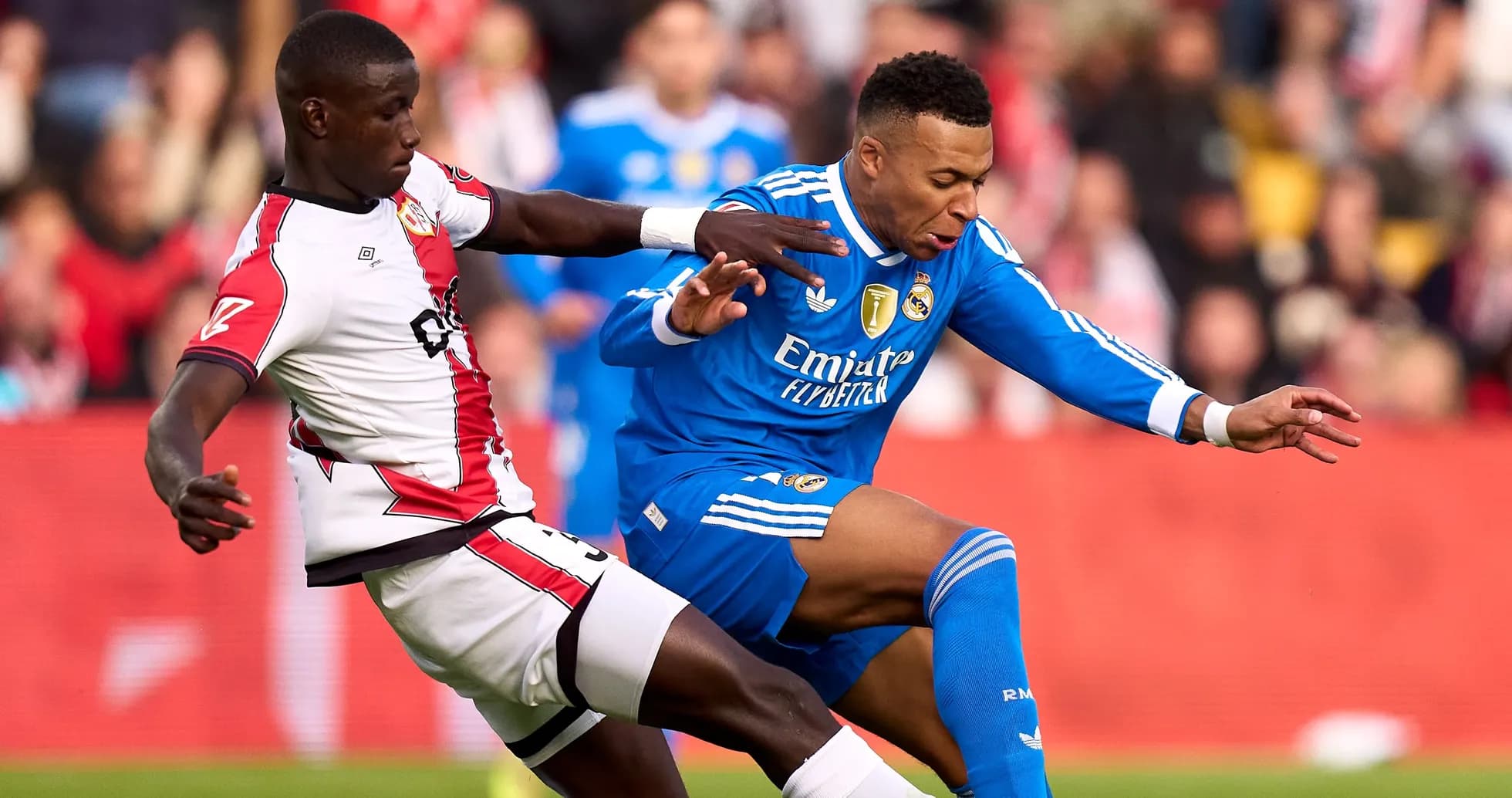 Jugador de Real Madrid siendo derribado por adversario