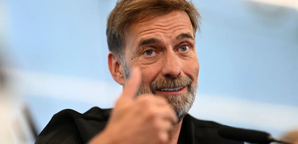 Entrenador hablando en conferencia de prensa con pulgar arriba