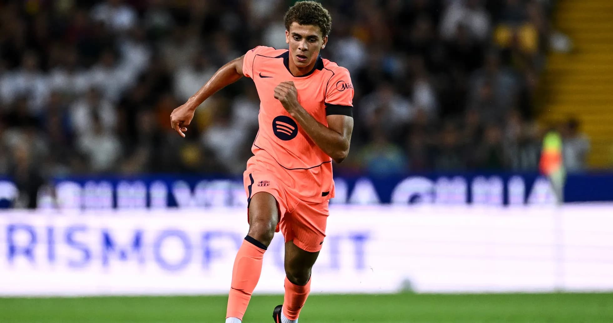 Jugador corriendo en uniforme rosa durante el partido
