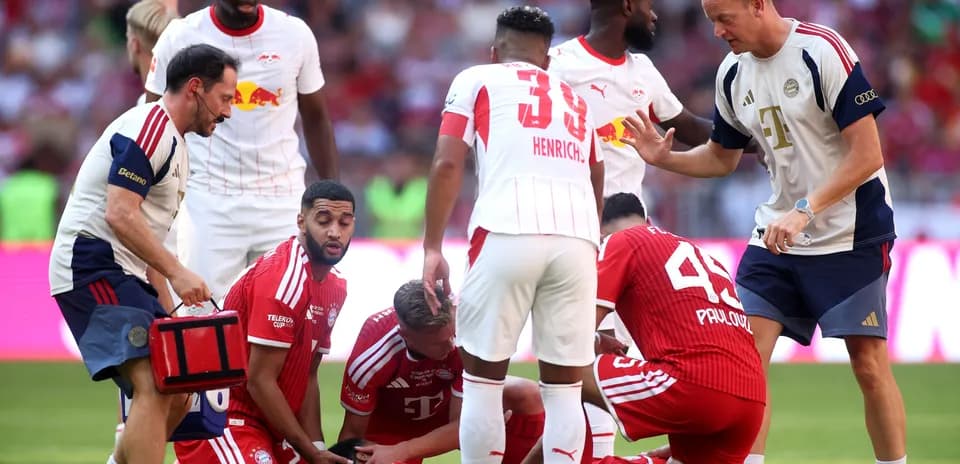 Jugadores de Bayern Munich atendiendo a compañero caído
