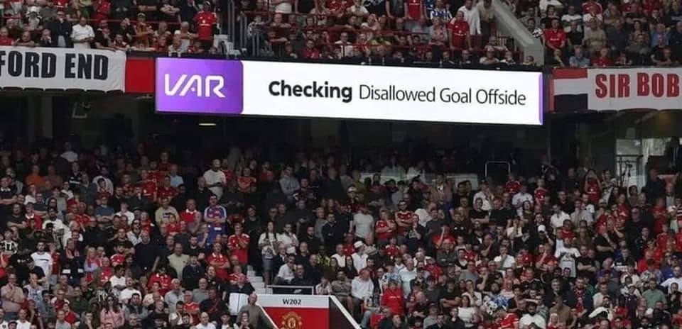 A crowd watching VAR decision on disallowed goal