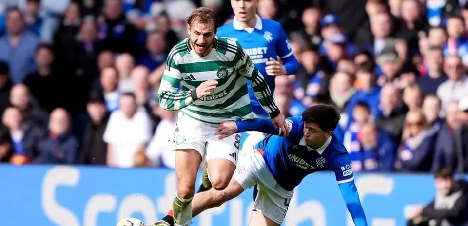 Jugador de Celtic siendo derribado por rival de Rangers