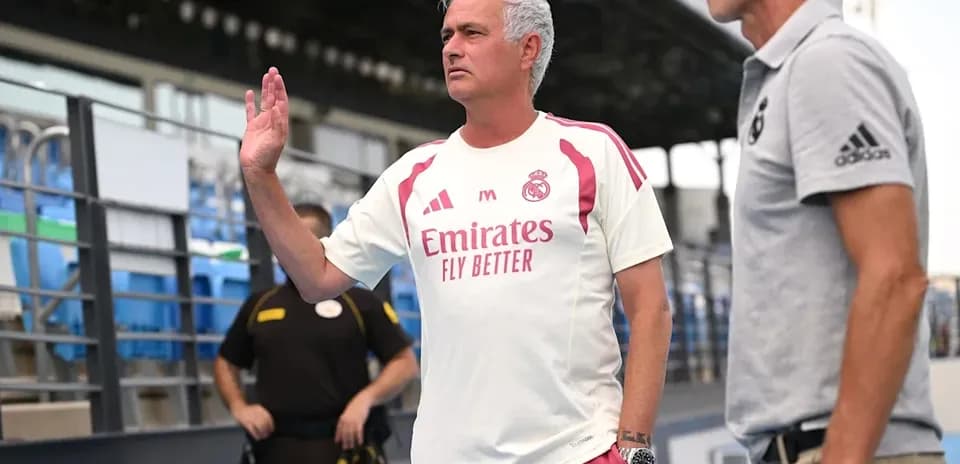 Entrenador saludando en la zona técnica