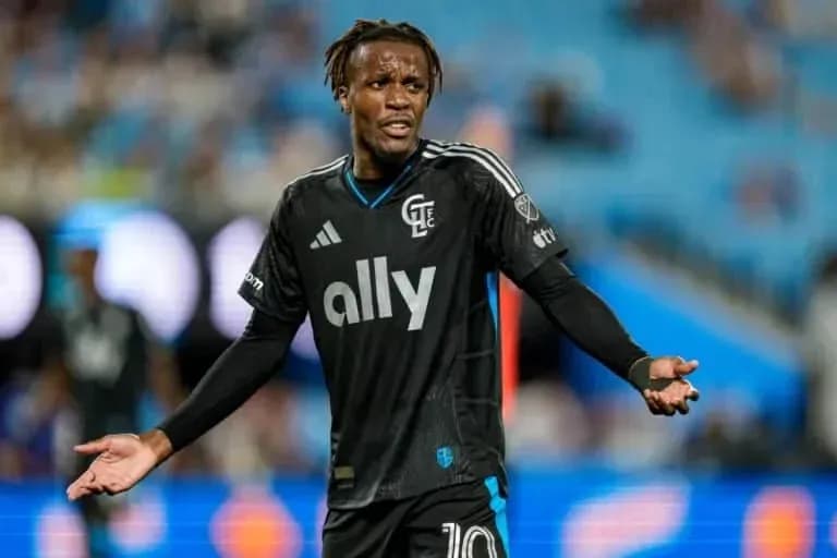 Jugador con camiseta negra gesticulando en el campo