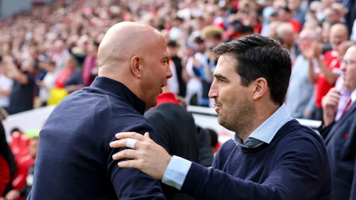 Entrenadores saludándose en el estadio lleno
