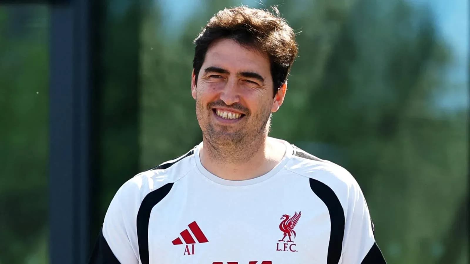 Entrenador sonriente en el campo de entrenamiento