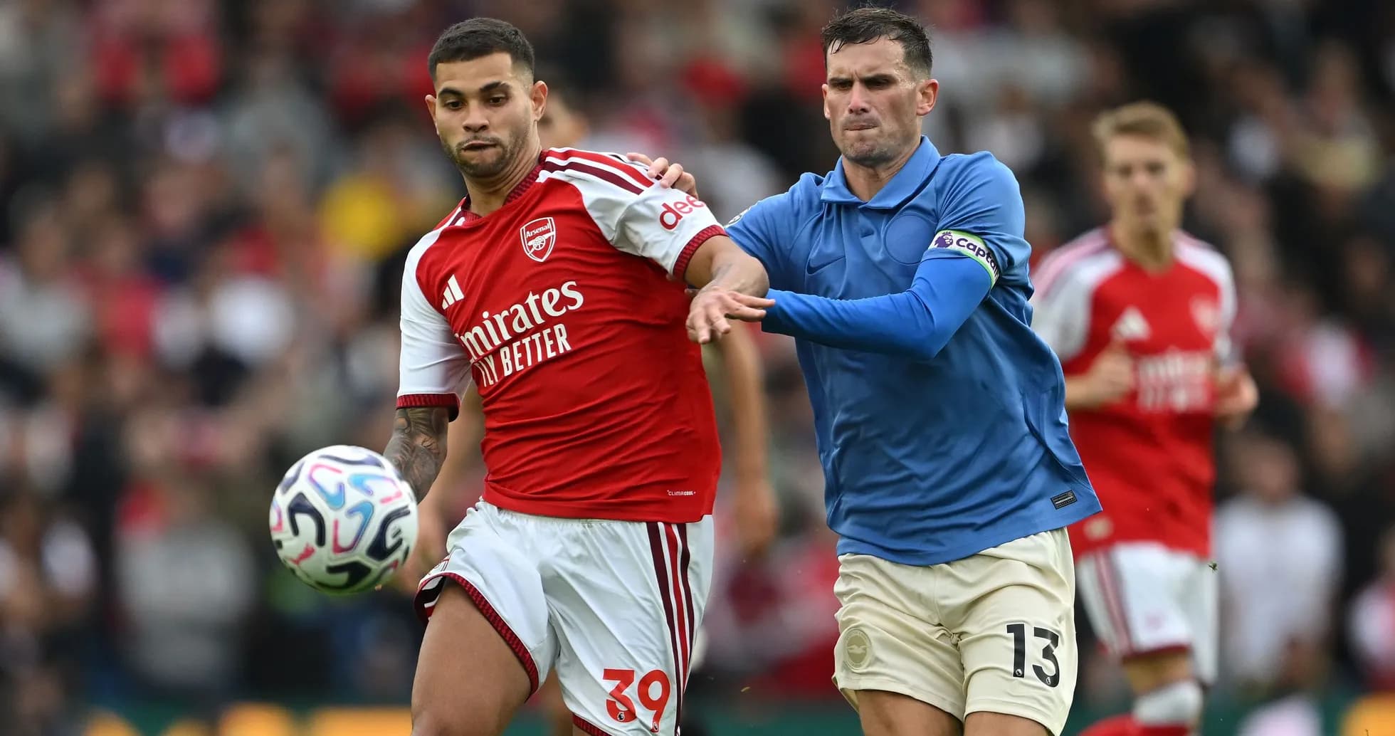 Jugador de Arsenal con balón perseguido por rival