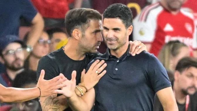 Dos entrenadores conversando durante un partido