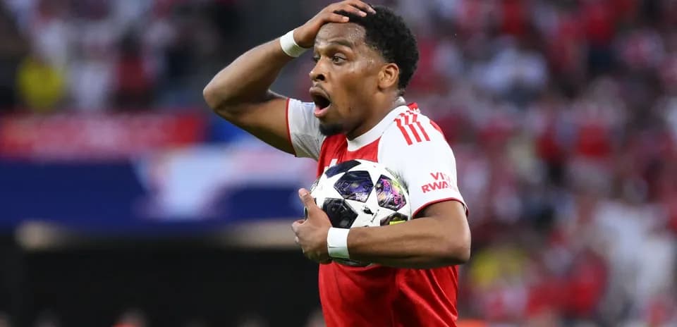 Jugador sosteniendo el balón con sorpresa durante partido