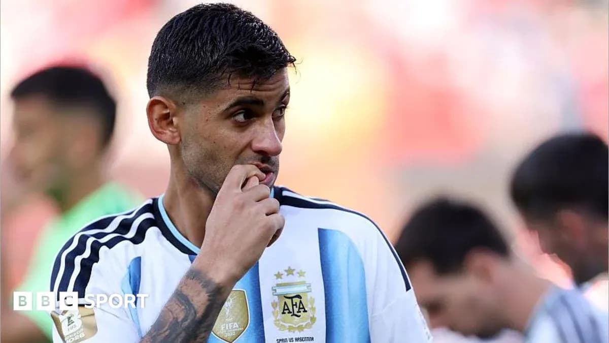 Jugador argentino con camiseta blanca y celeste pensativo