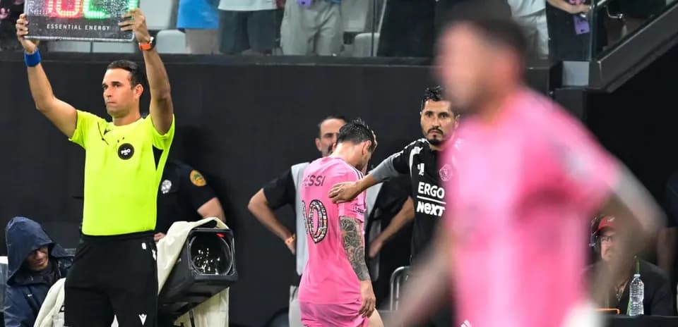 Jugador siendo sustituido en partido de fútbol