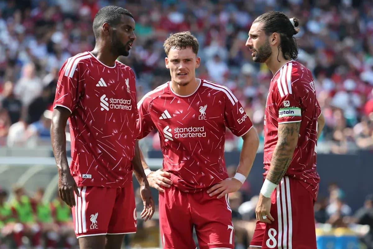 Jugadores de Liverpool conversando en el campo