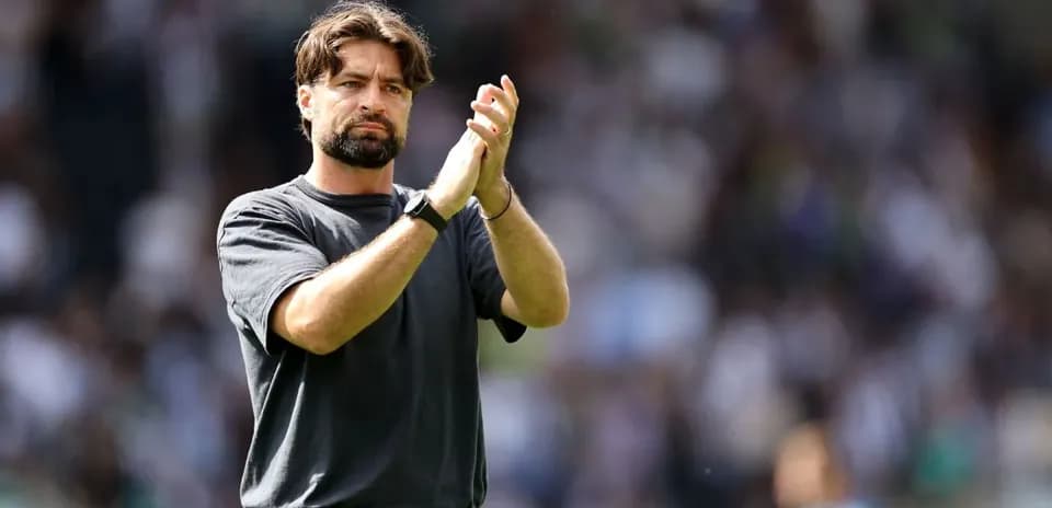 Entrenador aplaudiendo en el campo de juego