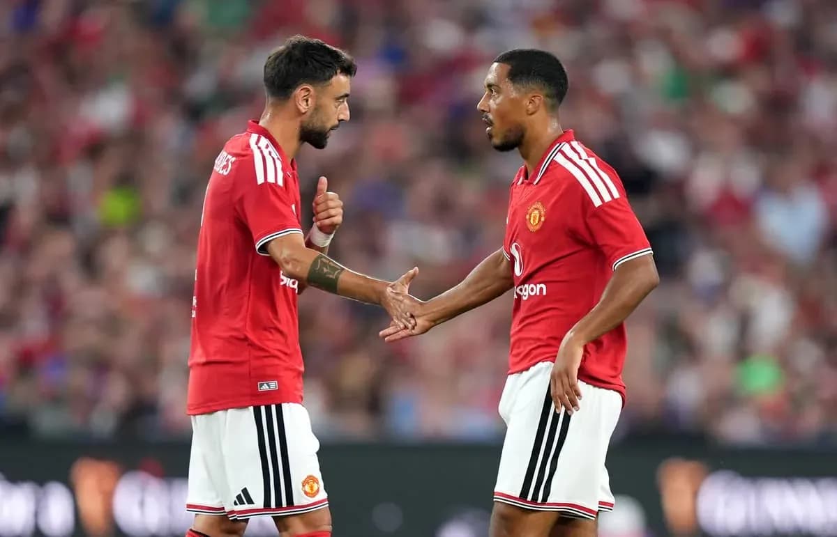 Jugadores de Manchester United intercambiando ideas en el campo