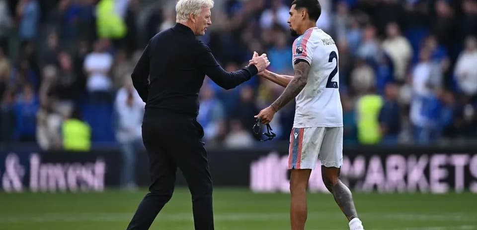 Entrenador y jugador saludándose tras el partido