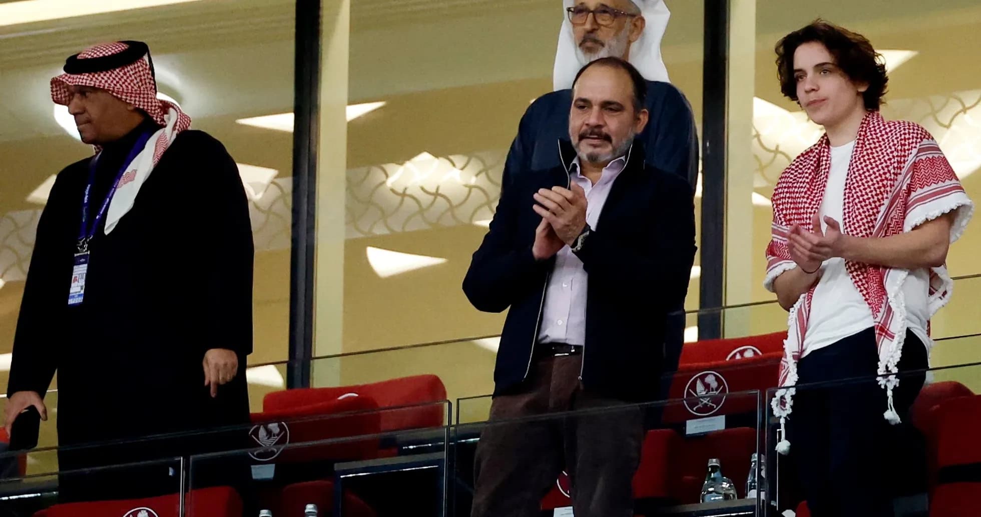 Cuatro personas en un palco aplaudiendo