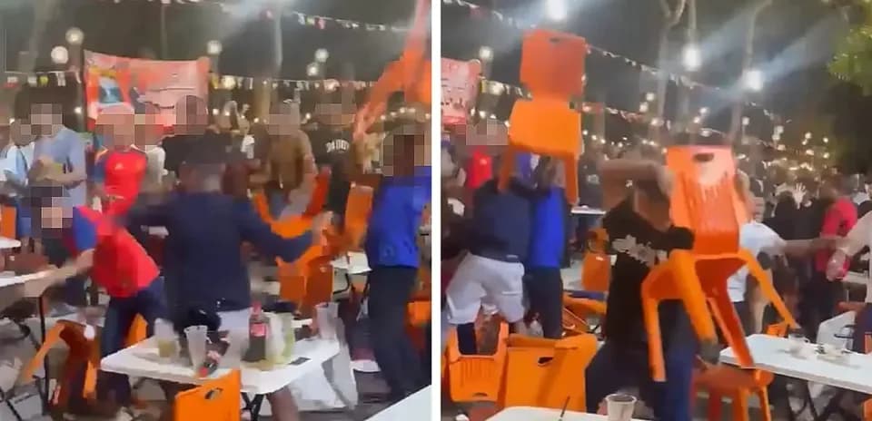 A chaotic scene with people throwing chairs in a bar