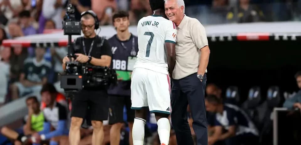 Vini Jr. conversando con el entrenador durante el partido