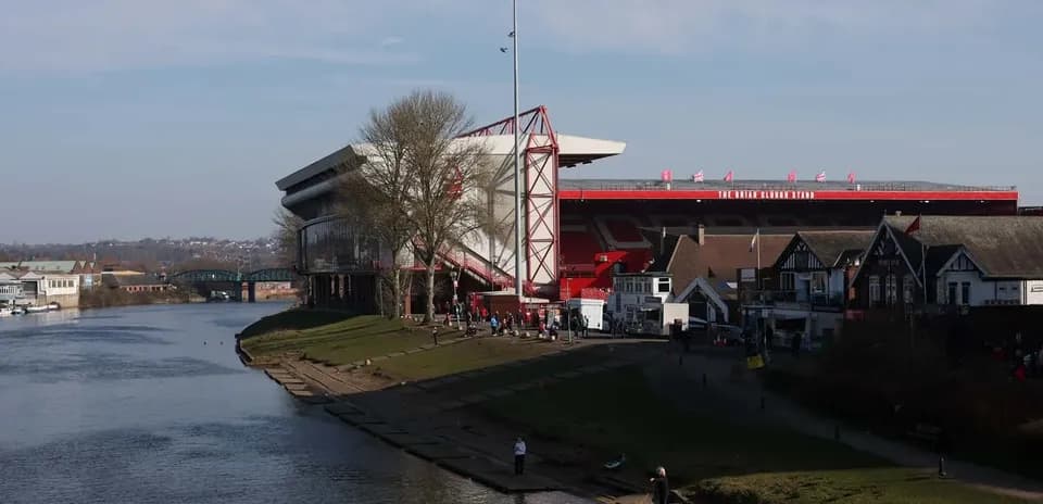 Estadio y río con gente en la orilla